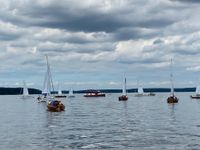 Viele Segelboote auf einem See beim Start der Regatta
